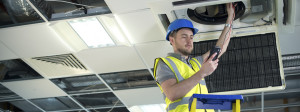 Air conditioning Engineer fitting air conditioning to office interior